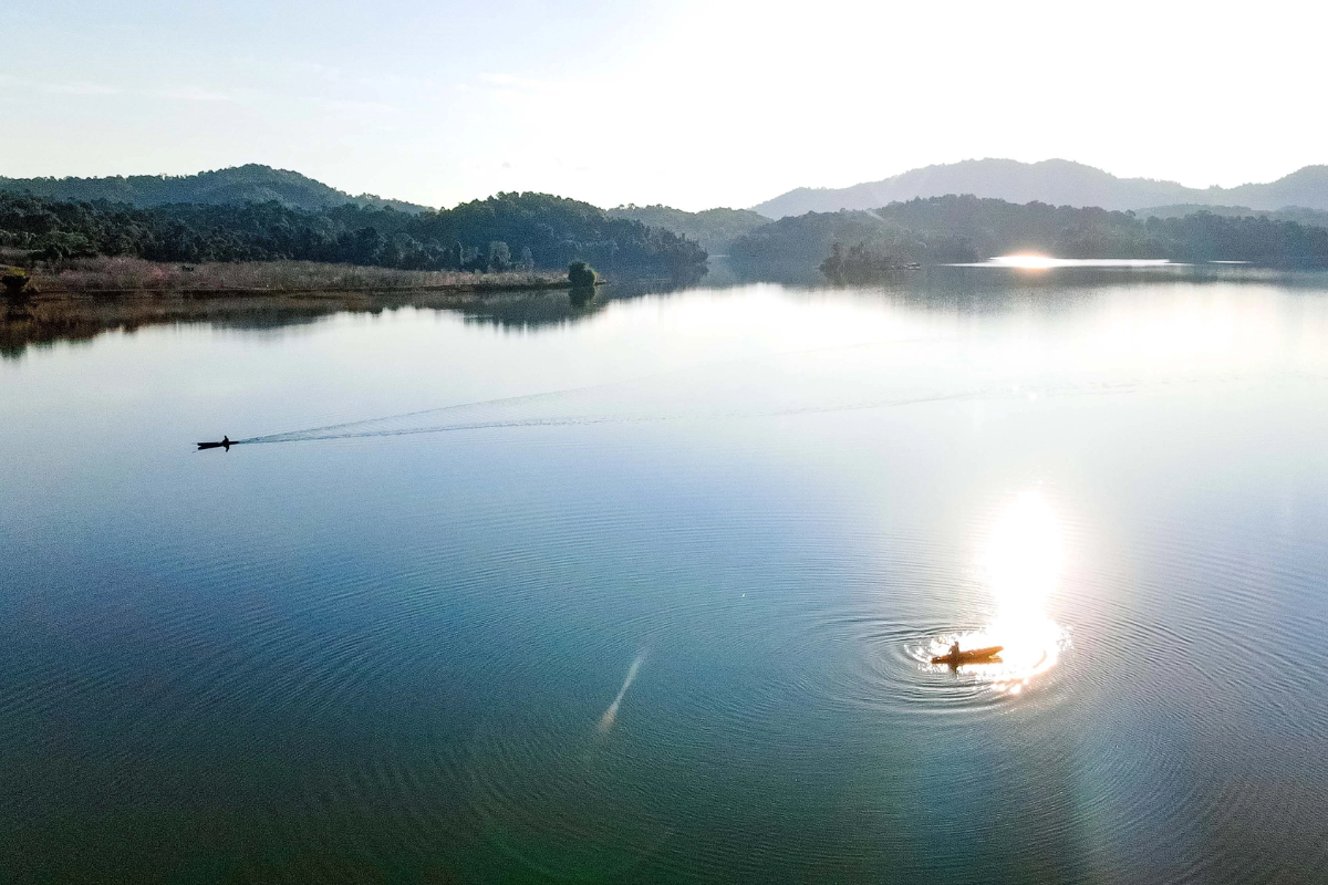 Sunrise illuminating the calm waters of Pa Khoang Lake 